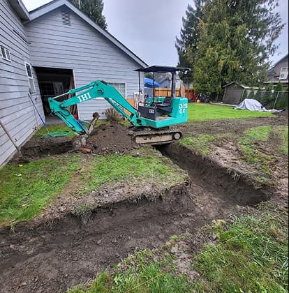 Excavator digging a path for footings