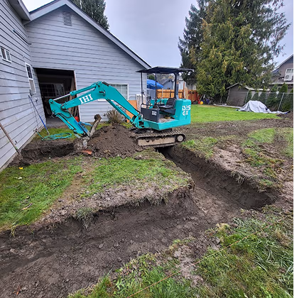 Excavator digging a path for footings